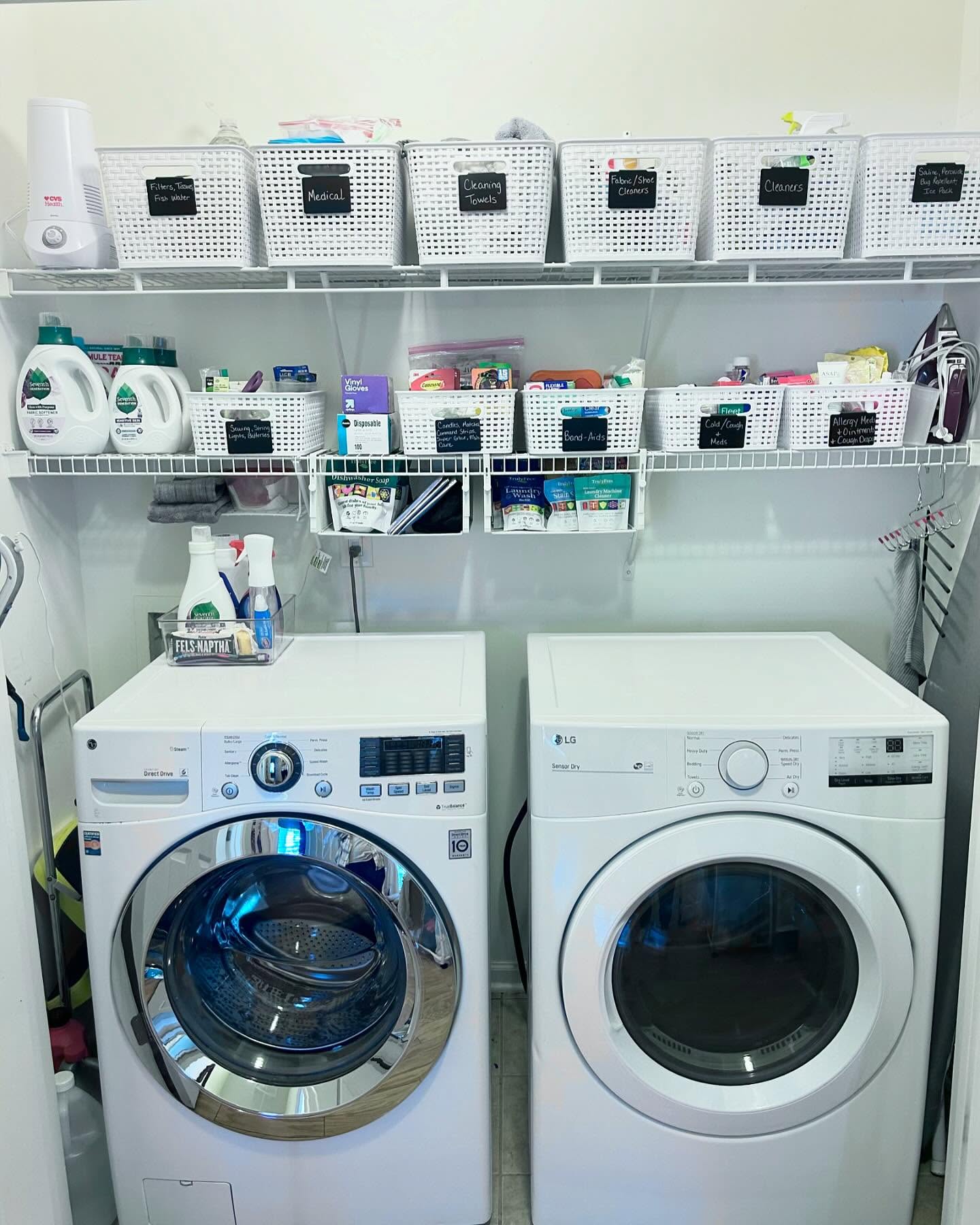 Organized small laundry room after Simply Stored — labeled white baskets sorted by category on wire shelving above washer and dryer