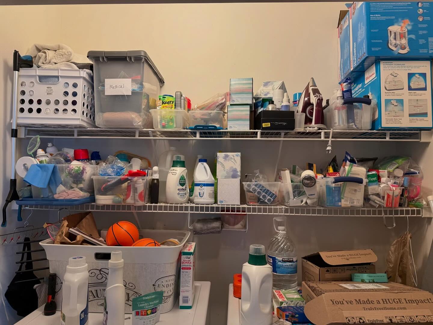 Cluttered laundry room wire shelves before professional organization — unsorted cleaning supplies, medical items, and laundry products