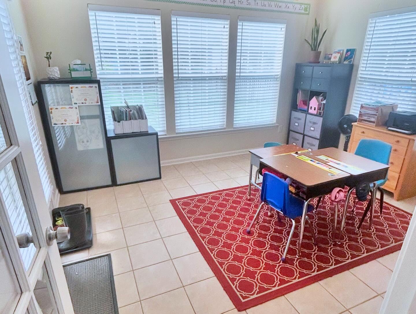Organized homeschool room after professional home organizing by Simply Stored — clear floor, tidy desks, calm learning space